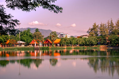 Scenic view of lake by buildings against sky