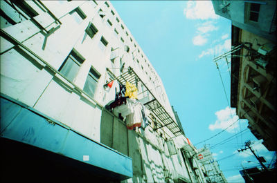 Low angle view of construction site against buildings in city