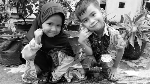 Portrait of cute girl sitting outdoors
