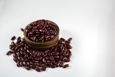 High angle view of coffee beans against white background