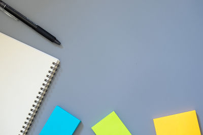 Low angle view of paper against blue background