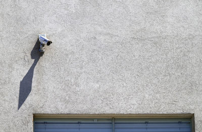 Surveillance camera on building with copy space