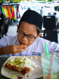 Portrait of girl with ice cream on table
