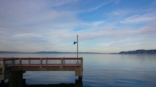 Pier over lake against sky