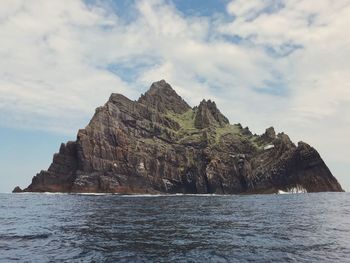 Scenic view of sea and mountains against sky