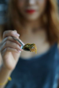 Midsection of woman holding food in spoon