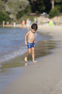 Side view of woman jumping in sea