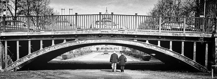 Woman standing on footbridge