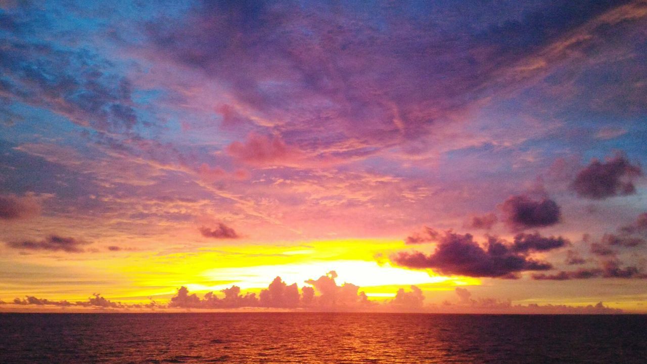 SCENIC VIEW OF SUNSET OVER SEA