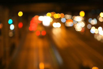 Defocused image of illuminated city at night