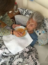 High angle view of people holding food at home