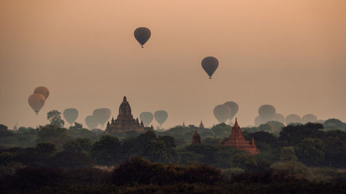 Hot air balloons against sky during sunset