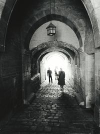 Rear view of people walking in corridor
