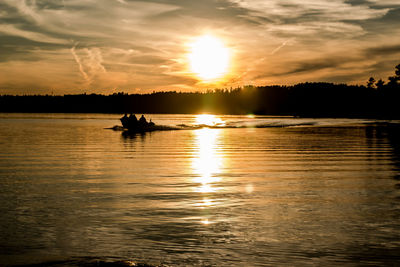 Scenic view of calm lake at sunset