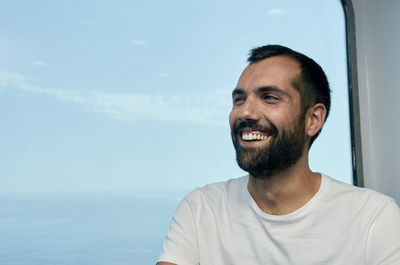 Portrait of smiling man against sky