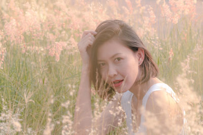 Portrait of smiling young woman on field