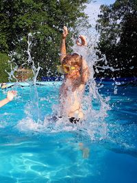 Boy enjoying while swimming in pool