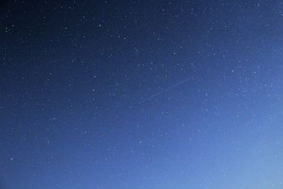 Low angle view of stars against clear blue sky