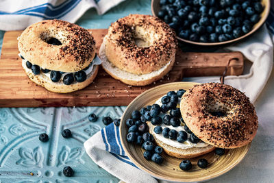 Sliced bagels with fresh whole blueberries and cream cheese spread