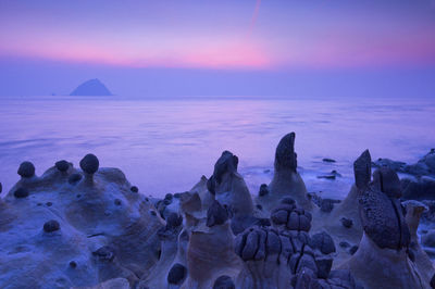 Scenic view of sea against sky at sunset