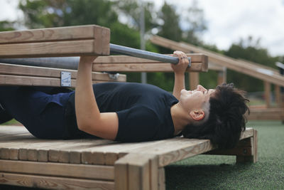 Young woman exercising at outdoor gym