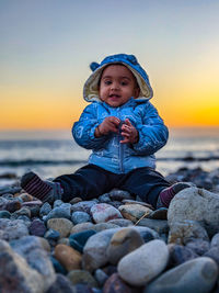 Portrait of cute baby standing at beach