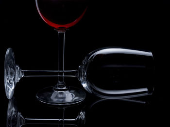 Close-up of wine glasses against black background