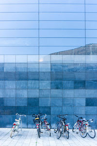 Bicycles in city against sky