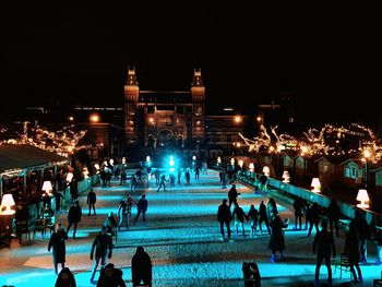 Crowd at illuminated city during winter at night