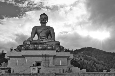 Low angle view of statue against cloudy sky