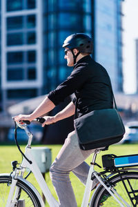 Businessman riding bicycle in city