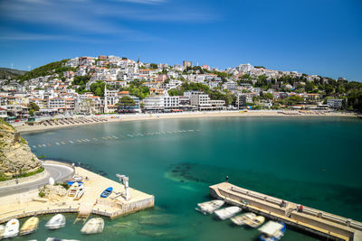 High angle view of buildings by sea against sky