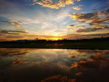 Scenic view of lake against sky during sunset