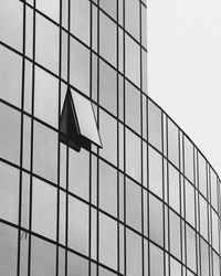 Low angle view of glass building against sky