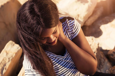 Midsection of woman relaxing on bed