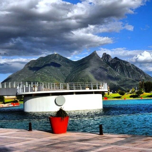 mountain, sky, water, cloud - sky, mountain range, cloud, lake, cloudy, tranquility, tranquil scene, built structure, railing, scenics, sea, nature, beauty in nature, blue, day, architecture, river