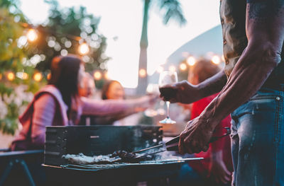 People standing on barbecue grill