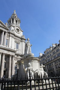 Statue of queen anne at outside the west front of st paul's cathedral in sunny day, london, uk