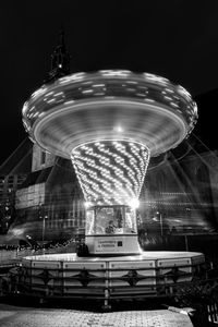 Blurred motion of illuminated ferris wheel at night