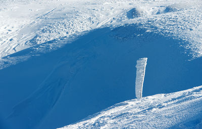 Icy  pole on snowy field