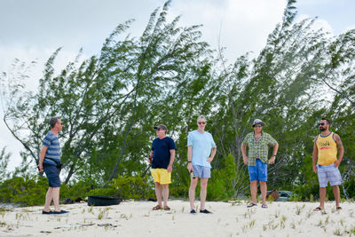 Group of people standing against trees