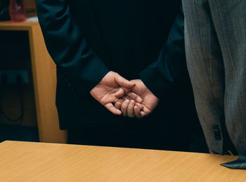 Cropped image of businessmen shaking hands in office