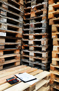 Office supplies on table against wood stack