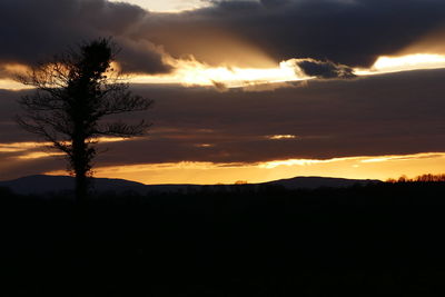 Silhouette of landscape against dramatic sky