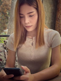 Beautiful young woman using mobile phone