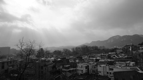 View of town against cloudy sky