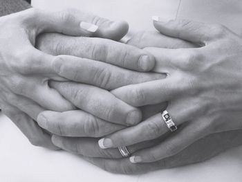 Close-up of father holding baby hand