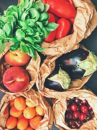 Directly above shot of fruits and vegetables in paper bags