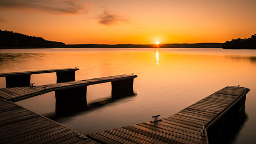 Scenic view of lake against orange sky