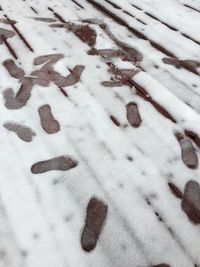 High angle view of footprints on snow covered land